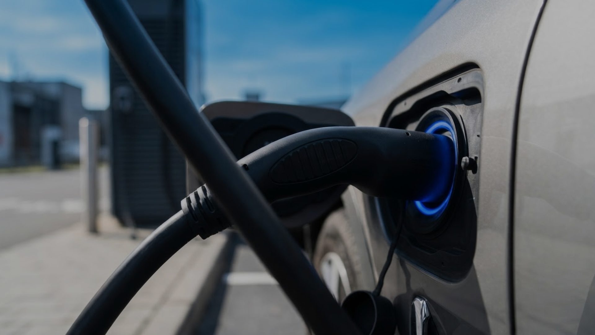 An electric vehicle charging cable plugged into a car
